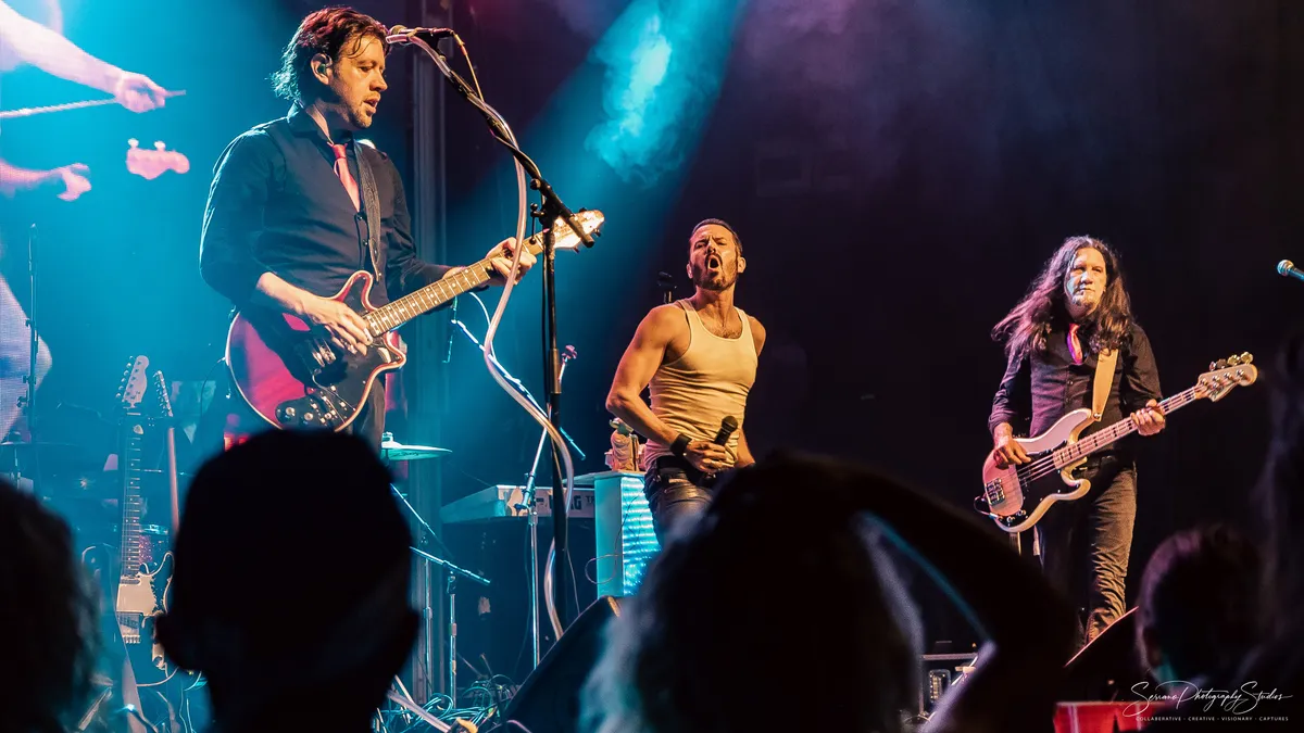 Lead guitarist performing 80s rock hits during a live music video dance party