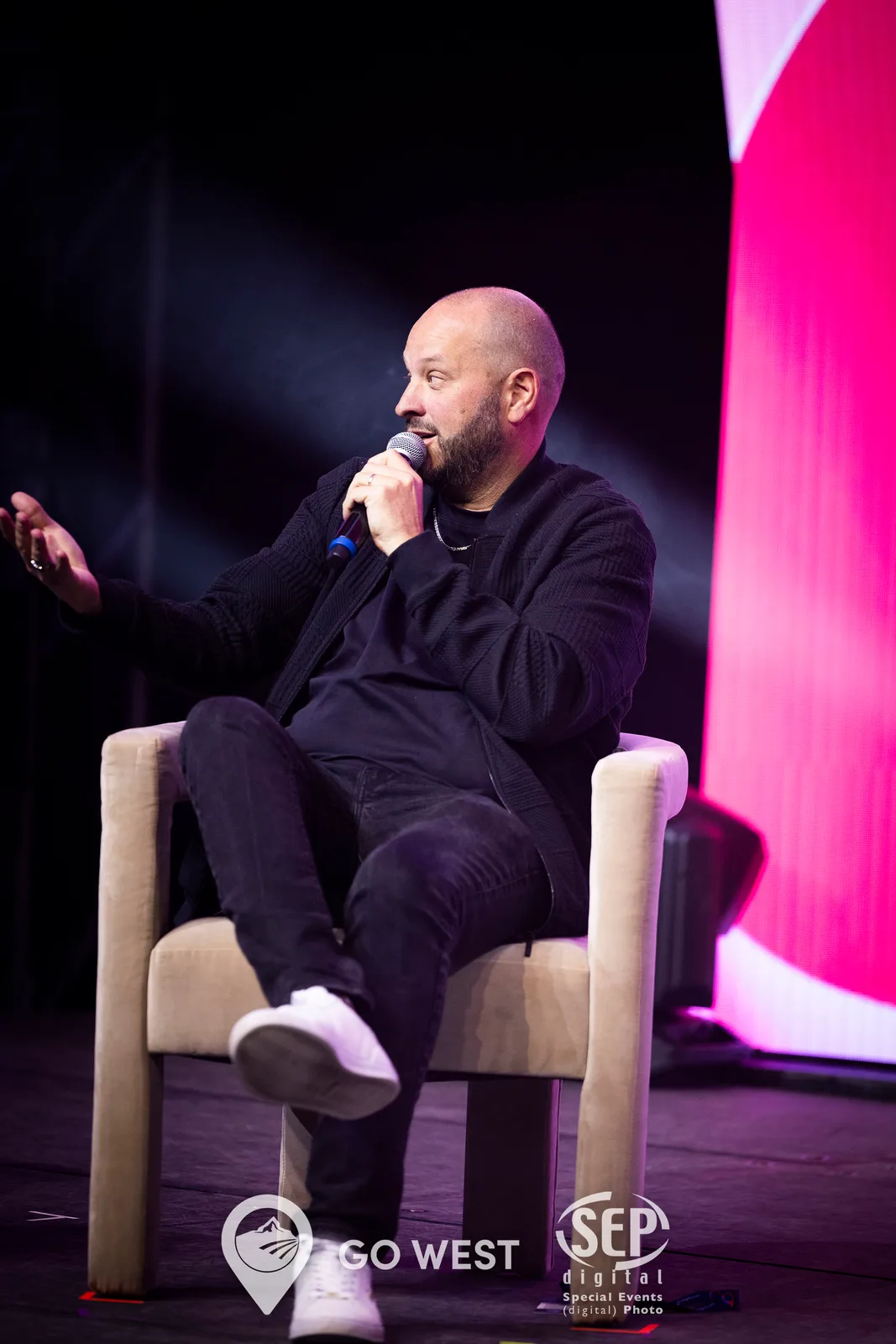 Toronto game show host on stage engaging corporate audience