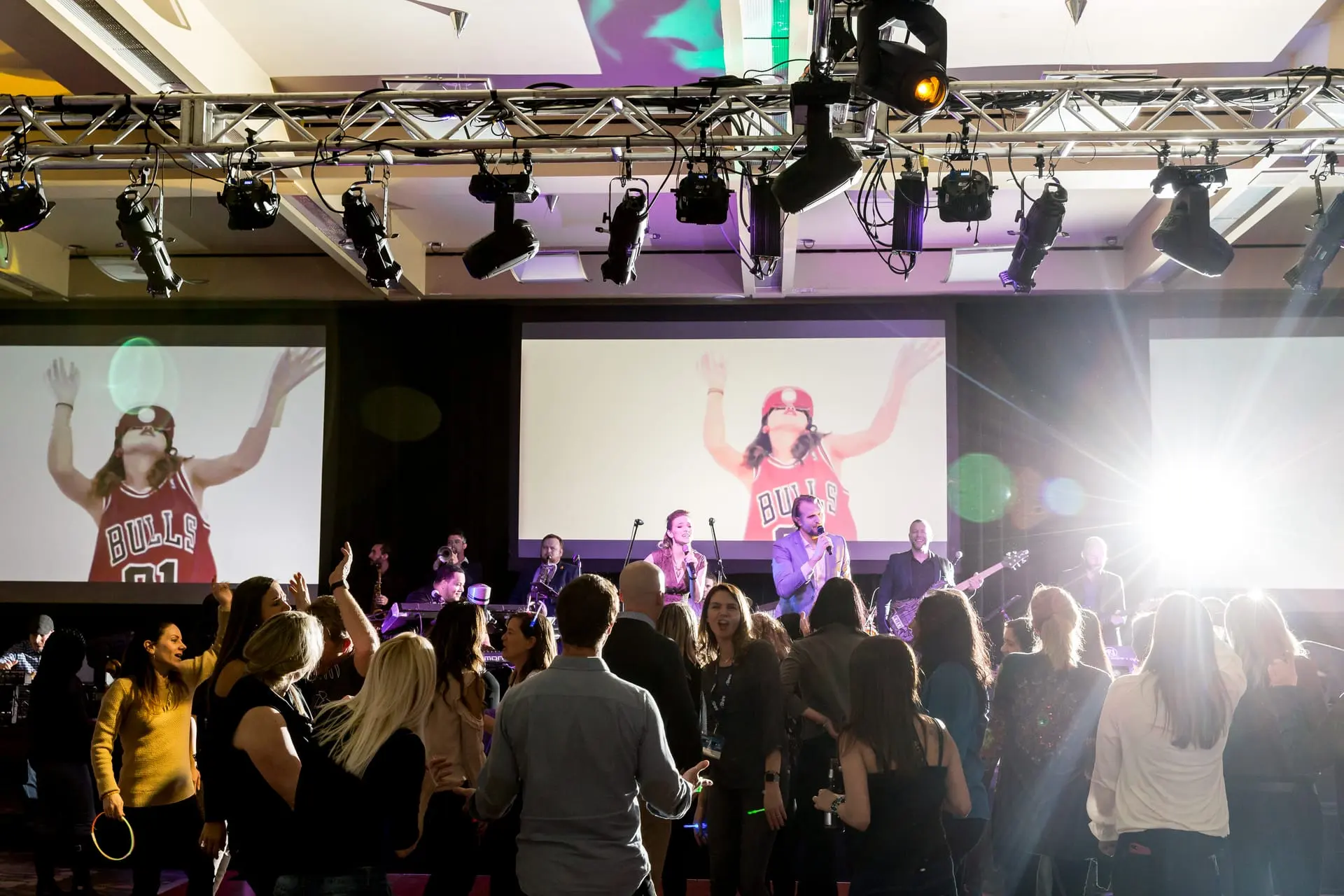 Guests on their feet at a Fusion Events corporate event as the band performs on stage
