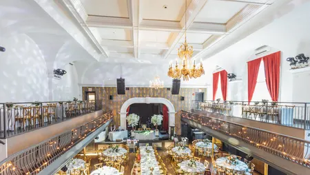 Toronto event venue set and styled by Fusion Events, with dinner tables, chandeliers and a balcony ready for guests