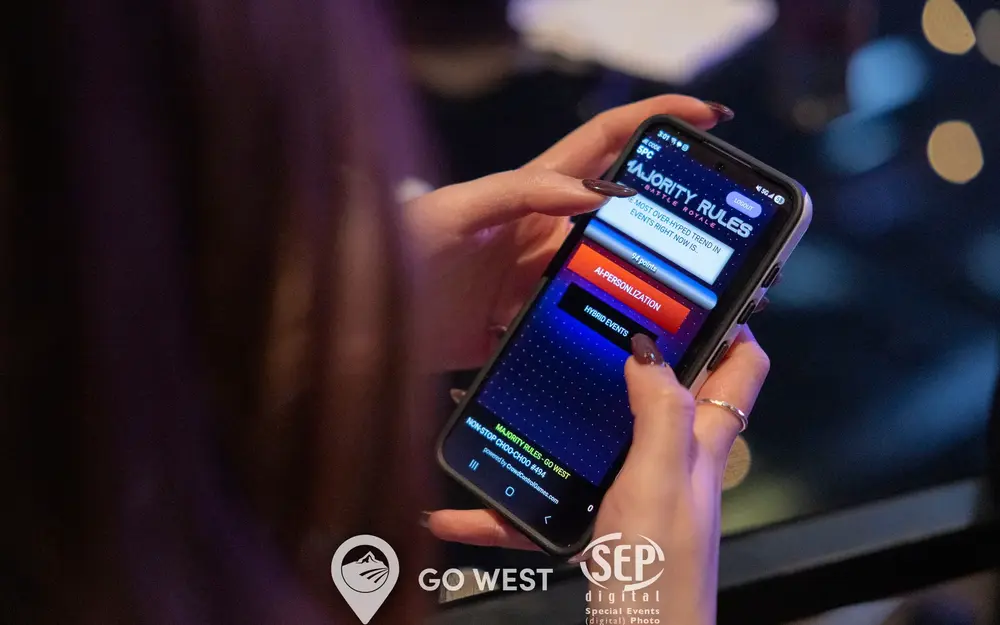 Conference guest voting on her phone during a Majority Rules game show