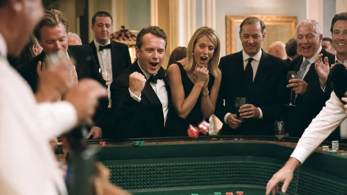 James Bond themed casino night with guests cheering at the craps table