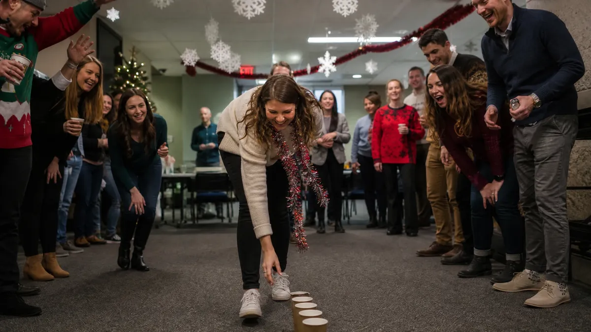 Two office teams cheering during a christmas party game at work