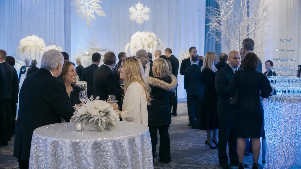 Winter wonderland themed corporate party with white and silver decor