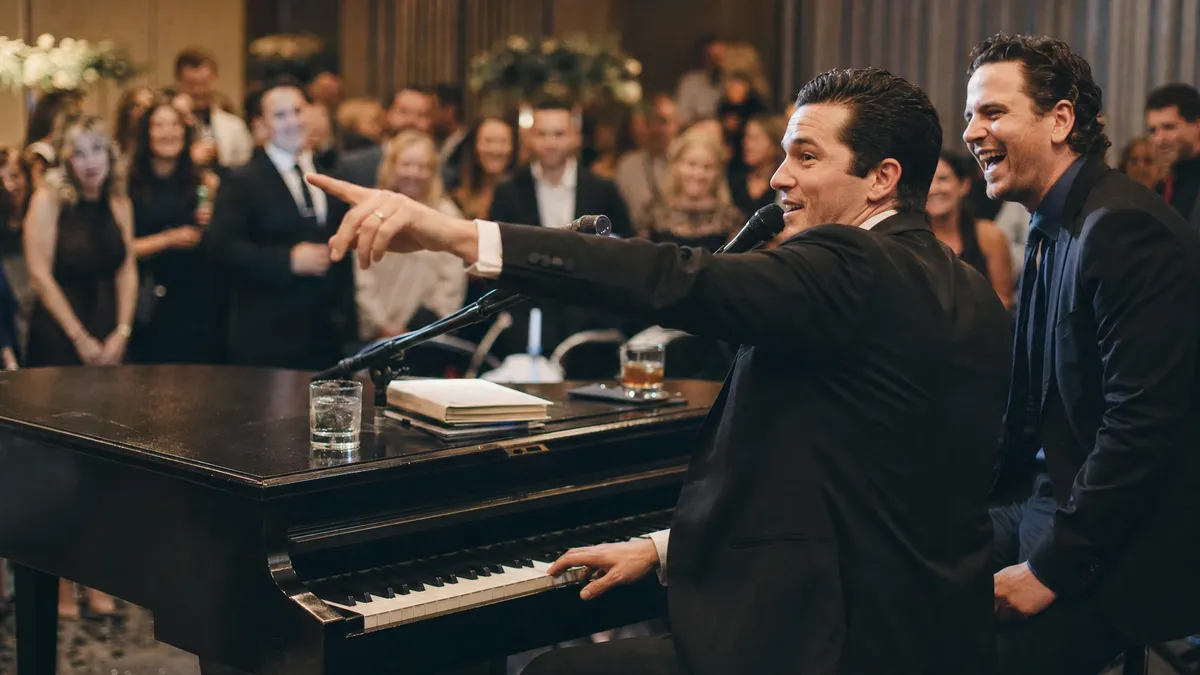 Dueling pianos performer taking a song request from the crowd