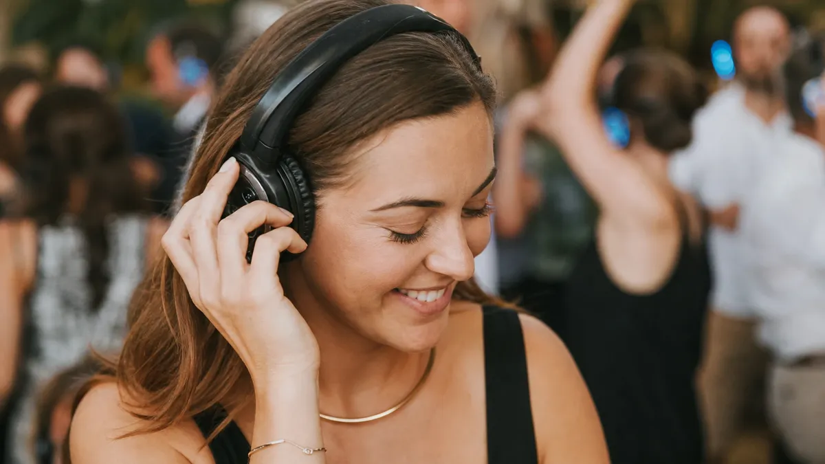 Guest switching channels on a silent disco headset mid-dance