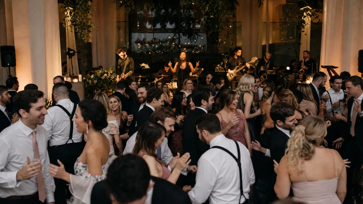 Live band performing at an elegant wedding reception with a full dance floor