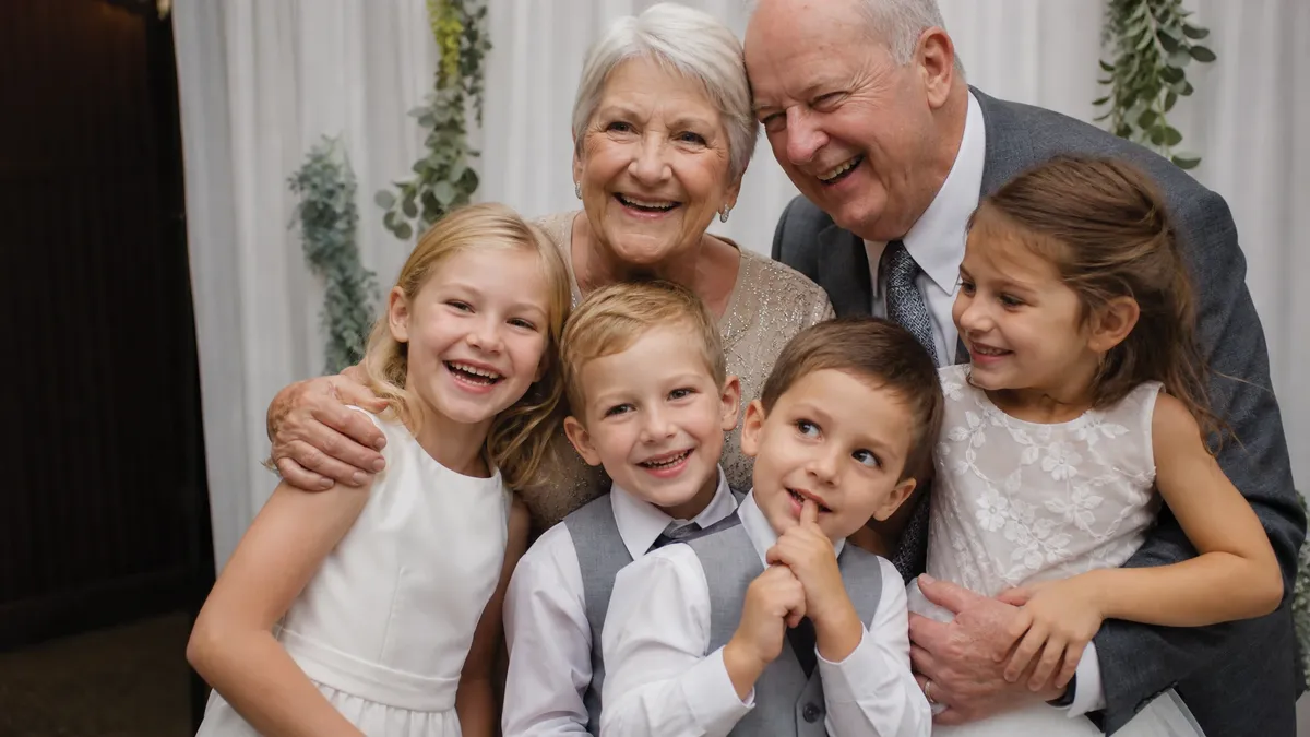 Grandparents and kids posing together in a wedding photo booth