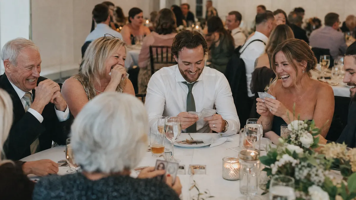 Wedding table playing a trivia game about the couple