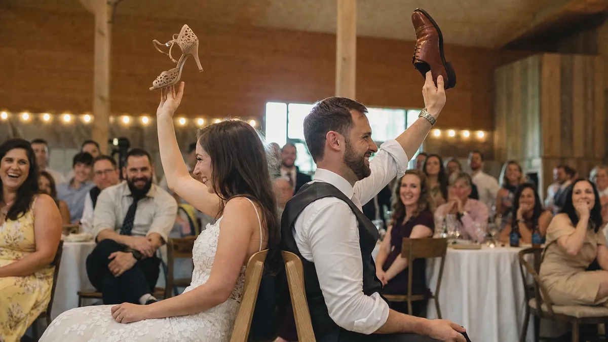 Bride and groom playing the shoe game at their wedding reception