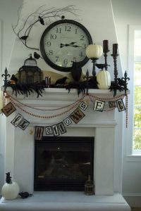 Fireplace mantle decorated in Halloween decor 