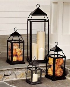 Lanterns with candles and small pumpkins 