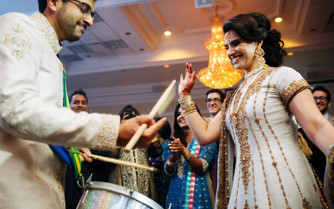 Bride and groom drumming at reception in a hindu wedding